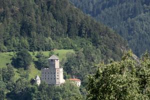 a building on top of a hill in a field at Chill Out Apartments in Landeck