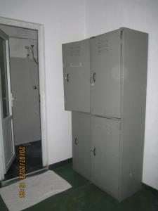 a room with four lockers in a room with a doorway at My city Beds in Kandy