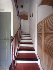 a staircase in a house with red tile at Dacamaloya in Volx
