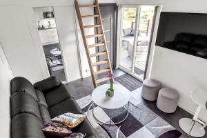 a living room with a couch and a ladder at Newly built Luxurious Guest house in Åkersberga