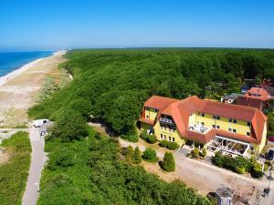 an aerial view of a house next to the beach at Seehotel Düne in Graal-Müritz