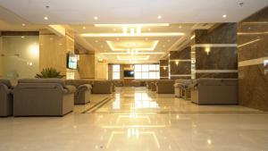 a lobby with couches and chairs in a building at فندق أفاق المشاعر in Makkah