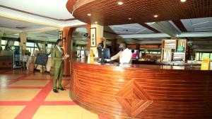 two men standing at a bar in a restaurant at Bunyonyi Safaris Resort in Kabale +68 photos