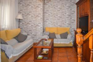 Sala de estar con 2 sofás y mesa de centro en CASA PUERTA ARABE, en Setenil