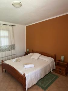 a bedroom with a bed with two towels on it at Agriturismo Su Barraccu in Loceri