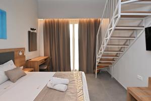 a bedroom with a bed and a spiral staircase at Maltepe Luxury Accommodation by Travel Pro Services in Kallithea Halkidikis