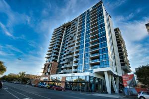 a tall building on the side of a street at Stunning 2BR Apt @ Adelaide CBD with Pool-Gym-BBQ in Adelaide