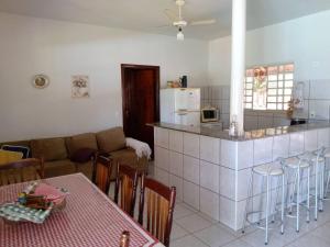 uma cozinha e uma sala de estar com um sofá e uma mesa em Rancho Rio Dourado, um paraíso! em Promissão