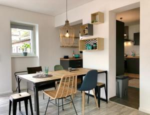 a kitchen and dining room with a table and chairs at Sweet Home Tholey in Tholey +15 photos