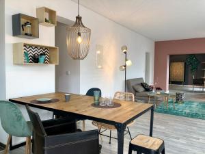 a dining room and living room with a table and chairs at Sweet Home Tholey in Tholey