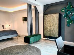 a bedroom with a bed and a green ottoman at Sweet Home Tholey in Tholey