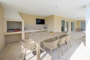 a dining room with a table and chairs at Villa Maja by IstriaLux in Orbanići