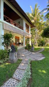 a house with a walkway in front of it at Bali Cottage Sambirenteng in Buleleng