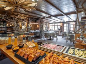 a buffet line with different types of food on a table at Hotel Eterlou in Méribel