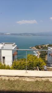 a view of the ocean and a white building at Deniz rezidans in Bodrum City