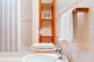 a bathroom with a toilet and a sink at B&B Dolce Sosta in Palinuro
