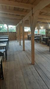 an empty room with wooden tables and benches at Guesthouse and restaurant SVANURI SAKHLI in Ushguli +55 photos