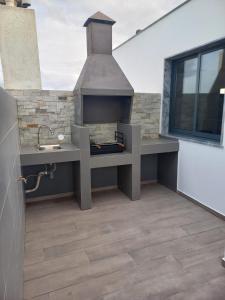 a kitchen with an outdoor stove in a kitchen at La Juanita - Residência Marina in Praia