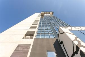 a tall building with a blue sky in the background at HTM Venice Suite in Mestre
