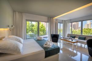 a bedroom with a large bed and a living room at Climia Belroy 4 Sup in Benidorm