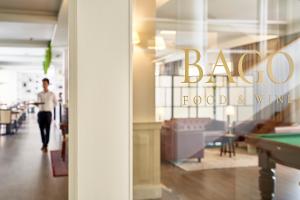 a man walks past a baroda food and wine store at Ribeira Collection Hotel by Piamonte Hotels in Arcos de Valdevez