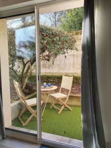 a sliding glass door with a table and chairs outside at Dolce vita en centre ville in Niort