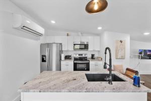 a kitchen with a sink and a counter top at Brand New on the Streetcar line in Cincinnati +3 photos