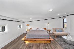 a bedroom with a bed and a tub in it at Brand New on the Streetcar line in Cincinnati