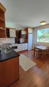 a kitchen with a table and a dining room at New 1 bedroom apartment near amenities nilsia near tahko in Nilsiä