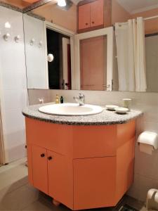 a bathroom counter with a sink and a mirror at Palazzo Luxury Suite - View to Liston square & Old Fortress of Corfu old town in Corfu Town