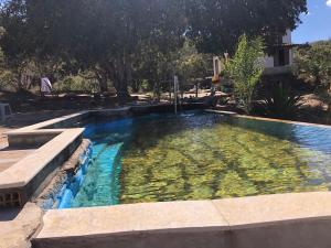 a large swimming pool with clear blue water at Estância do Biribiri in Diamantina