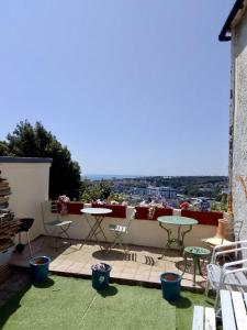 a patio with a table and chairs on a balcony at St Marys Apartment in Hastings