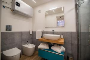 a bathroom with a sink and a toilet at GL Exclusive Luxury Suite in Procida