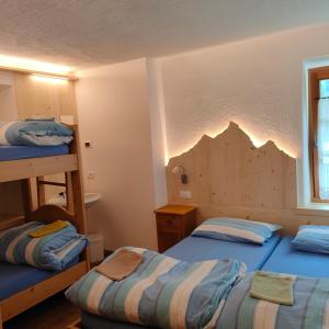 Postel nebo postele na pokoji v ubytování Rifugio Stella Alpina Spiz Piaz per escursionisti