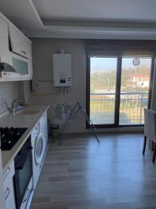 a kitchen with a sink and a stove at BMB GROUP ÇINARCIK HOME 3 in Çınarcık