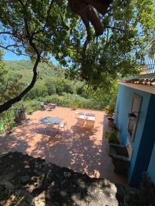 a patio with a table and chairs in front of a house at Agriturismo Etna-Mare in Piedimonte Etneo