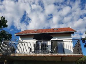 uma casa com uma varanda com um guarda-chuva em Apartmán Podyjí em Znojmo