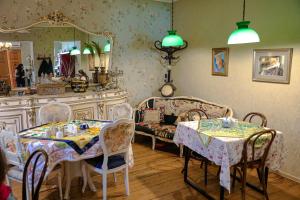 a living room with two tables and a mirror at Tatin - Hotel & Café in Mtskheta in Mtskheta