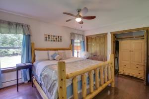 a bedroom with a bed and a ceiling fan at Spacious Cabin with Private Dock on Thompson Lake in Oxford