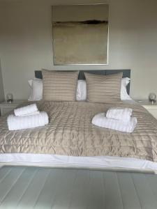 a large bed with two pillows on top of it at Seascape in Lynton