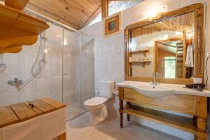 a bathroom with a toilet and a sink and a shower at Etenna Beach Bungalows in Cıralı