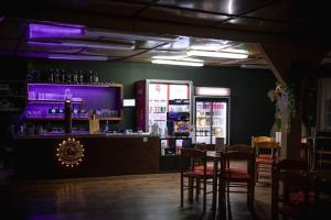 a bar in a restaurant with tables and chairs at Kemp Sluníčko in Doksy