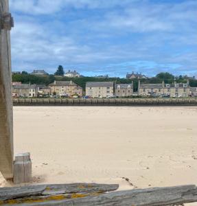 a view of the beach with buildings in the background at Seaview in Lossiemouth