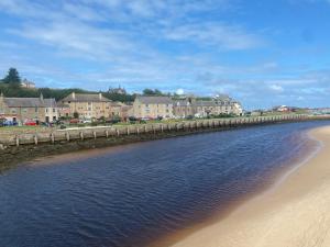a bridge over a beach with buildings in the background at Seaview in Lossiemouth