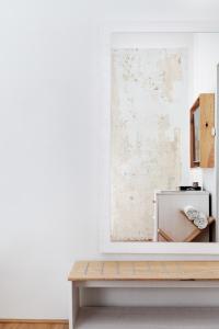 a white room with a table and a mirror at Grand Hôtel Wiesler - Centre of Graz in Graz