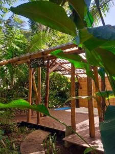 a wooden gazebo with a sign on it at Sitio Simple Life in Ubatuba