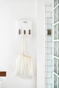 a white tote bag hanging on a wall at Grand Hôtel Wiesler - Centre of Graz in Graz
