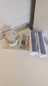 a bathroom counter with two towels and a container on it at Casa rural La Frambuesa in Galaroza