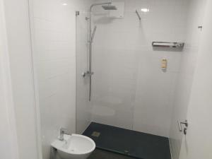 a bathroom with a shower with a toilet and a sink at Enjoy Viseu in Viseu