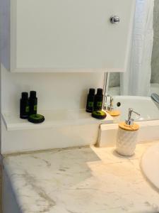 a bathroom with a sink and a white counter at Lydia House in Korinthos